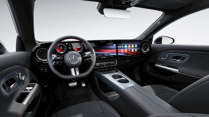 Das Cockpit des Mercedes-Benz CLA Elektrisch zeigt Sportlenkrad, breite digitale Displays, Runddüsen und rote Kontrastnähte im dunklen Innenraum.