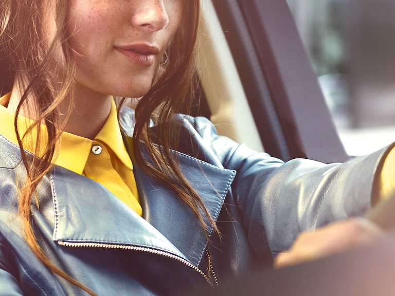 Have a safe journey with the Mercedes-Benz warranty for new vehicles. | Mercedes-Benz A relaxed man is sitting in front of his Mercedes with his tablet.
