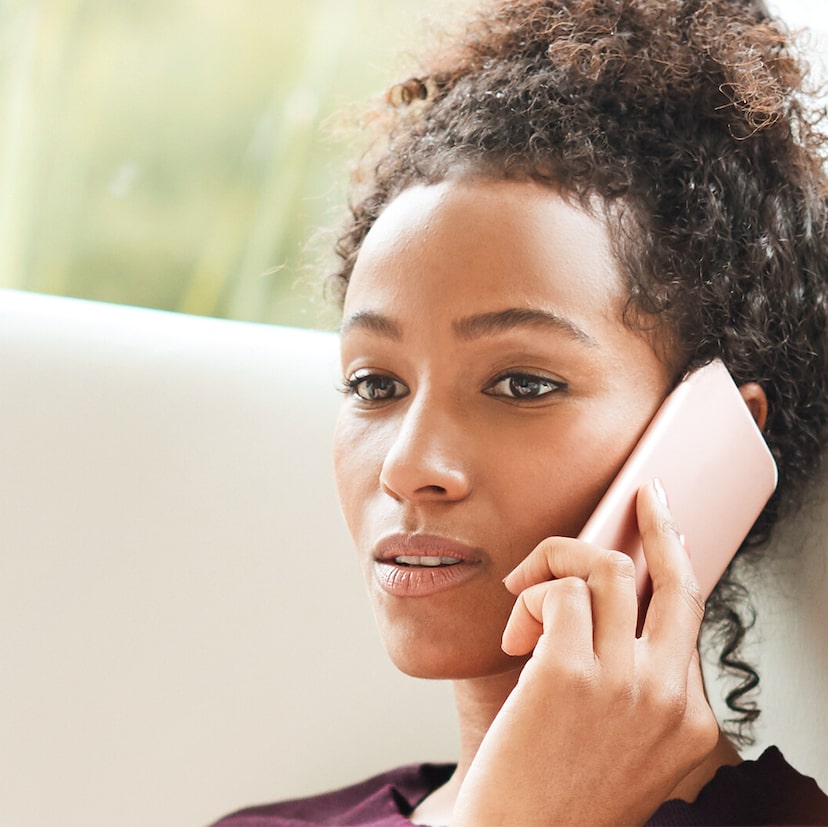 A woman making a phone call on her smartphone.