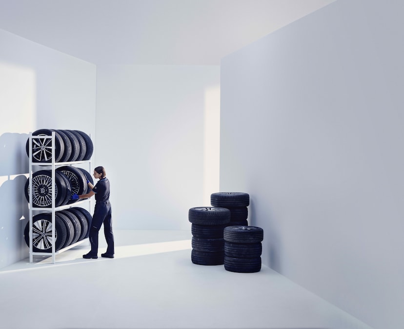 A Mercedes-Benz technician stores Mercedes-Benz Original tires on a shelf.