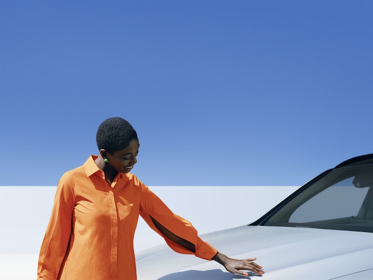 A person standing next to a Mercedes-Benz vehicle.
