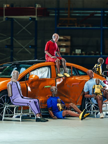 Crash test dummies | Safety | Mercedes-Benz Multiple crash test dummies sitting on and arround a Mercedes-Benz car.