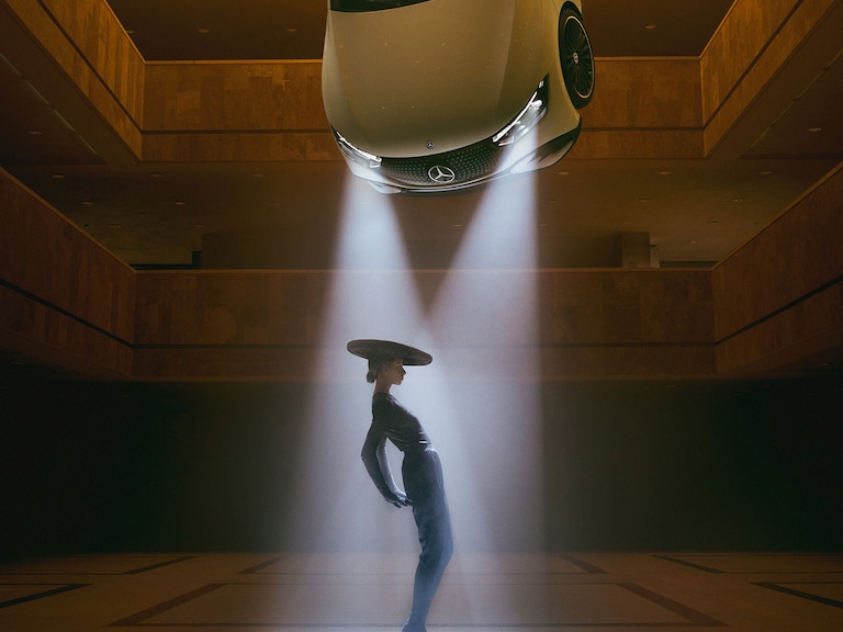 Enhancing your life | Technology | Mercedes-Benz A dancing person in the headlights of an floating car by Mercedes-Benz.