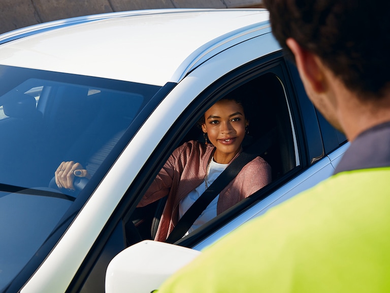 Roadside Assistance | Mercedes-Benz A woman is looking at her digital service report on her tablet.
